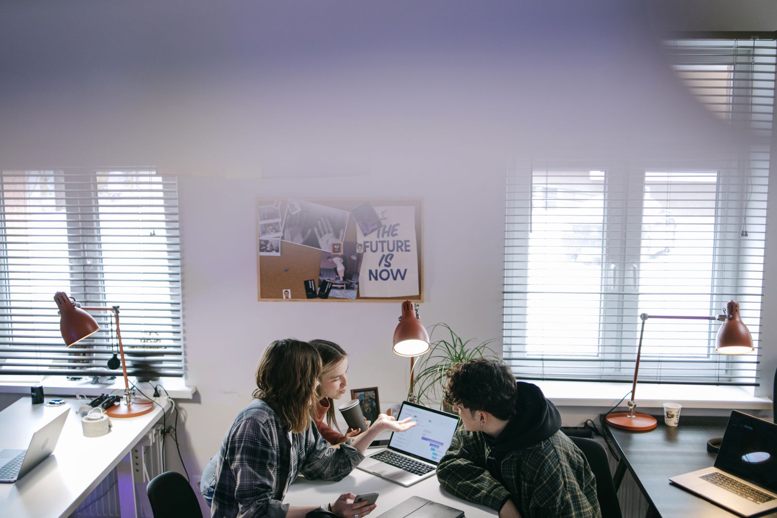 A small office with people at their desks