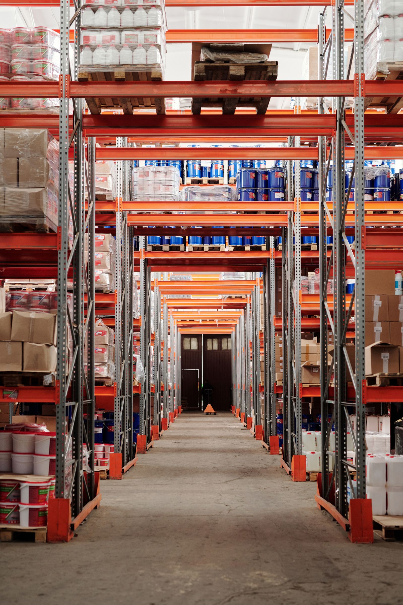 Warehouse interior with tall orange shelving